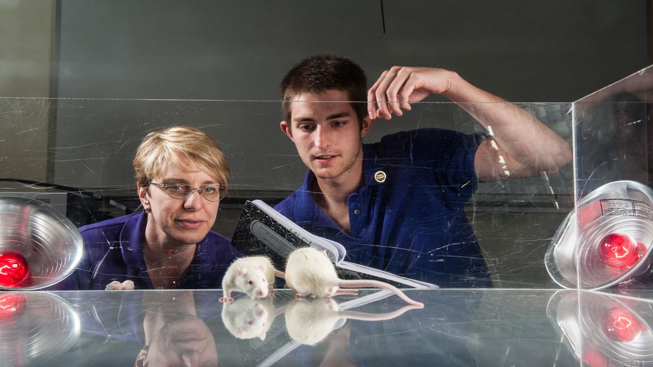 Lora Becker with student and rats